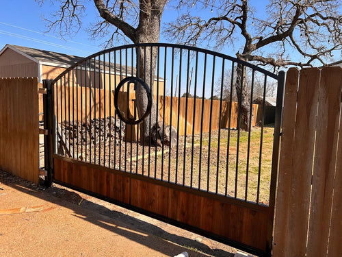 Arch top driveway gate showing curved rail and square picket infill detail — heavy-gauge steel | GateBound
