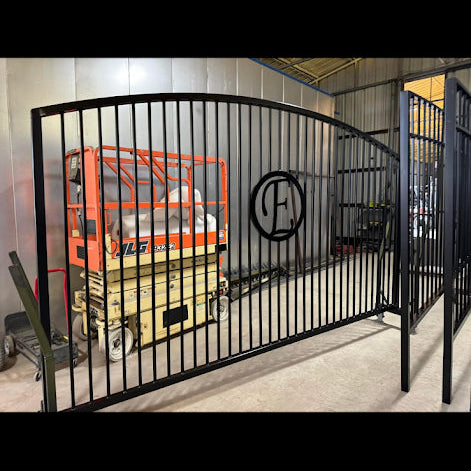 Arch top steel driveway gate with decorative curved top rail, powder coated flat black — built to order in Waco, TX | GateBound